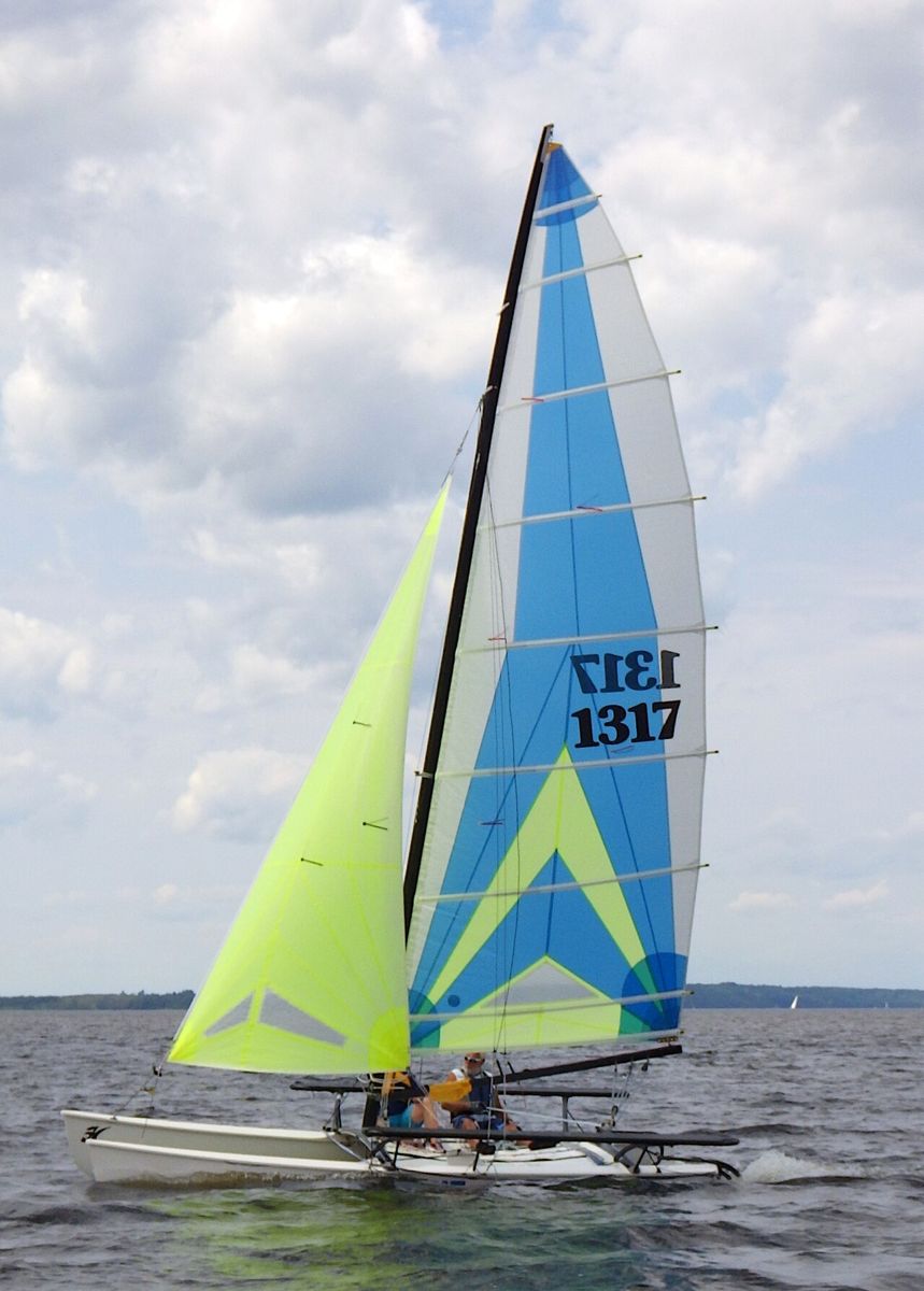 A Hobie 18 catamaran rigged on a beach